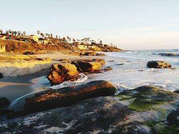 Rocks on beach against sky