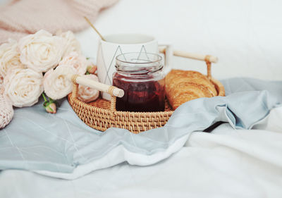 Romantic breakfast with coffee, croissants and rose flowers.