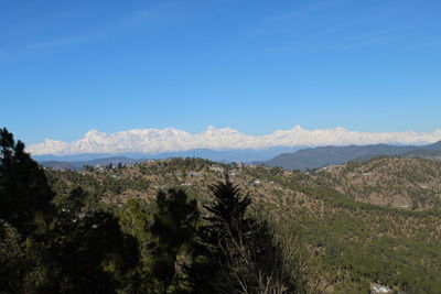 Scenic view of mountains against clear blue sky