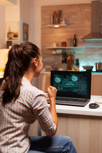 Woman using laptop at home