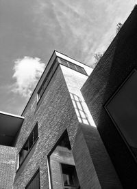 Low angle view of building against cloudy sky