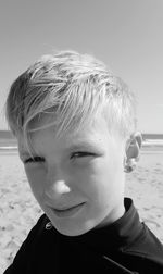 Close-up portrait of smiling boy on beach