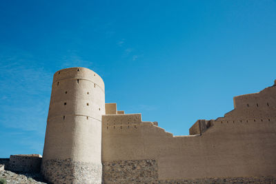 Low angle view of fort against blue sky