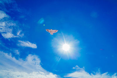 Low angle view of airplane flying against sky