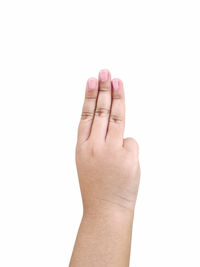 Close-up of human hand against white background