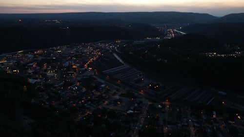 High angle view of illuminated buildings in city at night