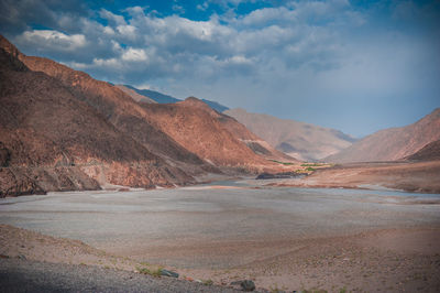 Scenic view of mountain against cloudy sky