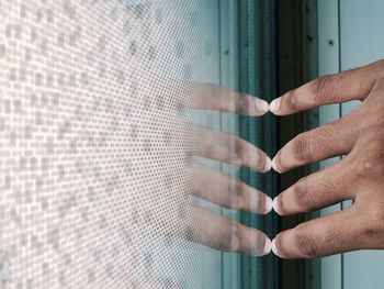 Close-up of man's hand touching futuristic screen