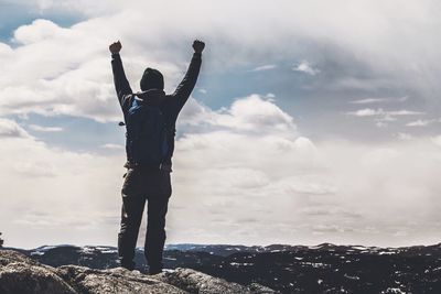 Man standing on landscape against sky