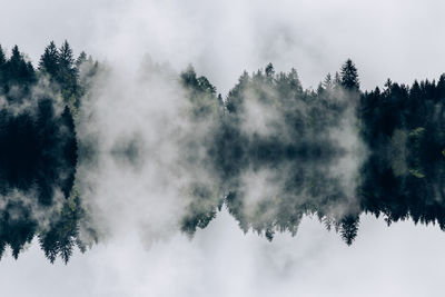 Panoramic view of waterfall in forest against sky