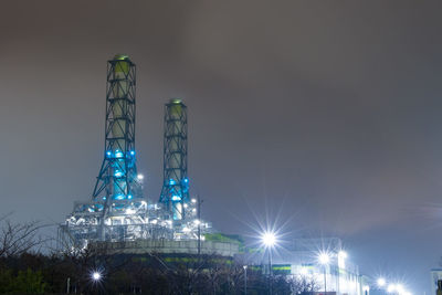 Illuminated buildings against sky at night