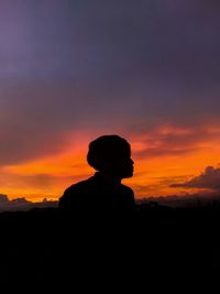 Silhouette man standing against sky during sunset