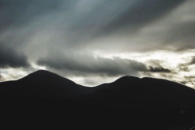 Scenic view of mountain against dramatic sky