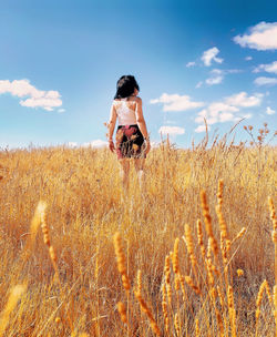 Woman on field against sky