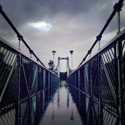 Bridge over footbridge against sky