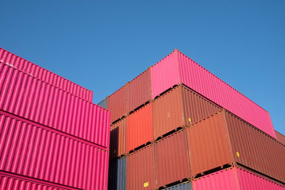 Low angle view of pink building against clear blue sky