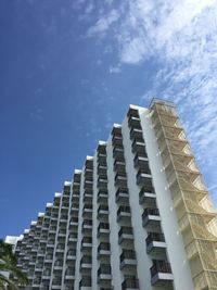 Low angle view of modern buildings against blue sky