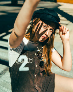 Portrait of woman wearing hat standing outdoors