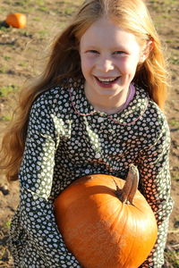 Close-up portrait of smiling girl on field