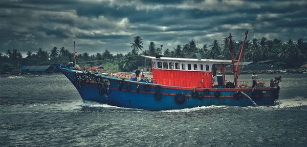 Boats moored on sea against sky