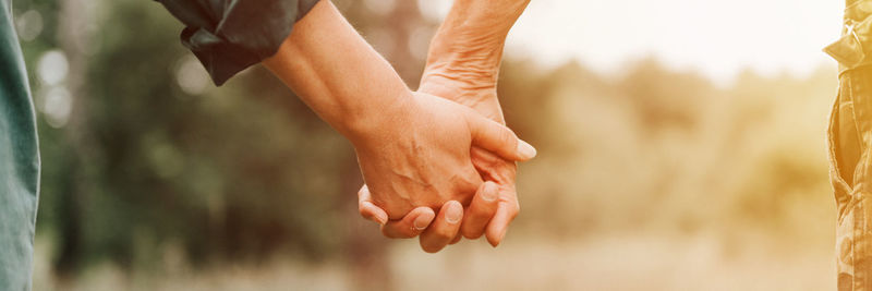 Happy senior couple holding hands. hands of man and woman hold each other. romance and love