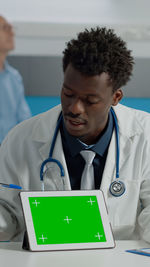 Portrait of doctor holding stethoscope at clinic