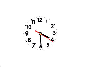 Close-up of clock over white background