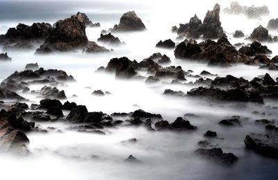Scenic view of waterfall against sky