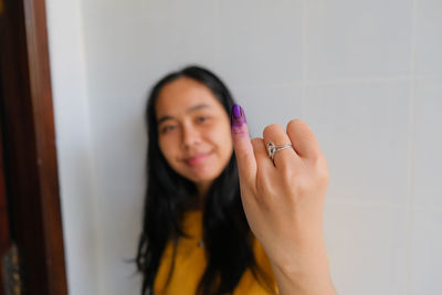 Close-up of woman with ink on fingers