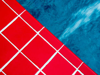 Vivid red ceramic tile beside the swimming pool