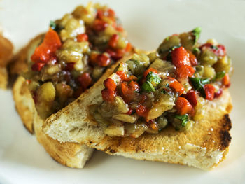 Close-up of bruschetta on toasted baguette served in plate