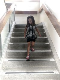 Full length portrait of woman on staircase