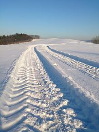 Snow covered landscape against sky