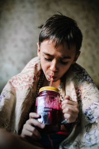 Boy drinking juice in container