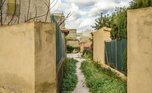 Narrow walkway leading to building