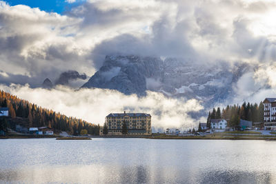 Panoramic shot of river by buildings against sky