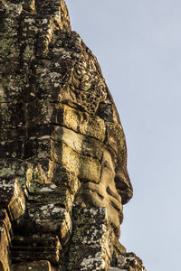 Low angle view of old temple against building