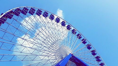 Low angle view of ferris wheel against blue sky