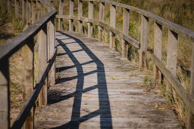 Shadow of railing on footpath