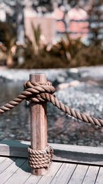 Close-up of rope tied on metal chain