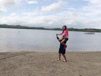 Full length of boy on beach against sky