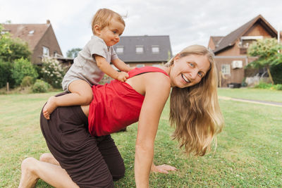 Portrait of woman playing with daughter