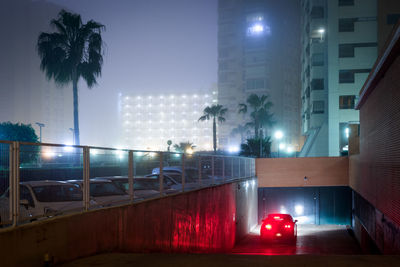 Illuminated street light in city at night