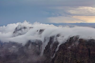 Scenic view of rocky mountains against cloudy sky