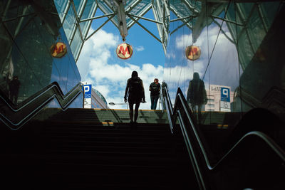 Low angle view of women moving up on steps