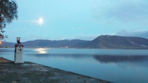 Scenic view of sea and mountains against sky