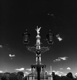 Low angle view of street light against cloudy sky