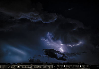 Low angle view of lightning against sky at night