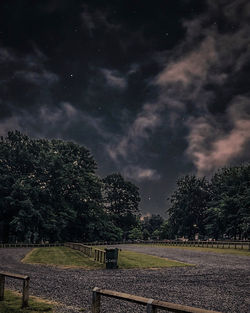 Trees on field against sky at night