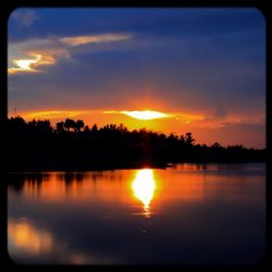 Scenic view of lake at sunset